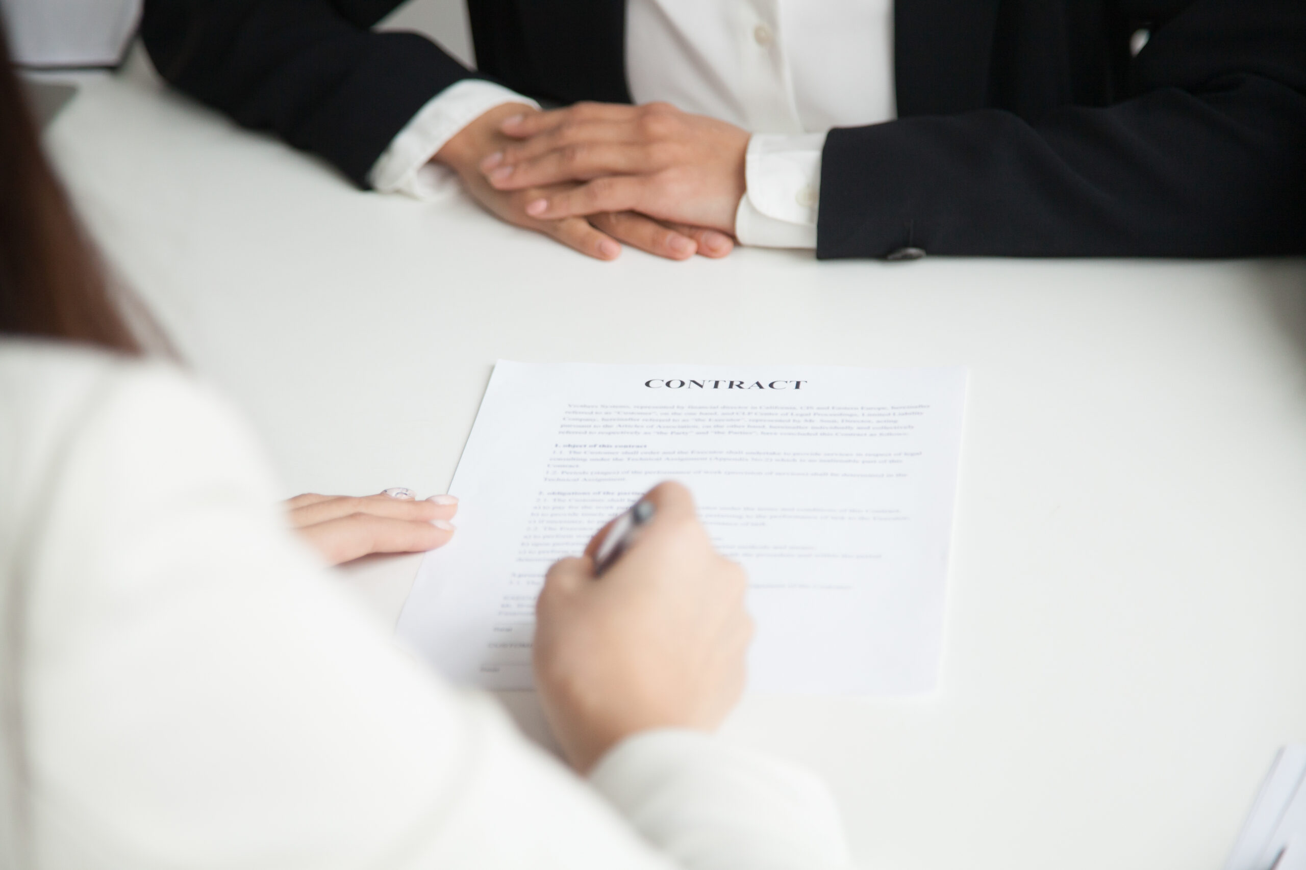 Close up of female job candidate signing contract, starting new job at company office. Intern closing deal for paid internship, filling agreement putting signature. Concept of employment, recruitment