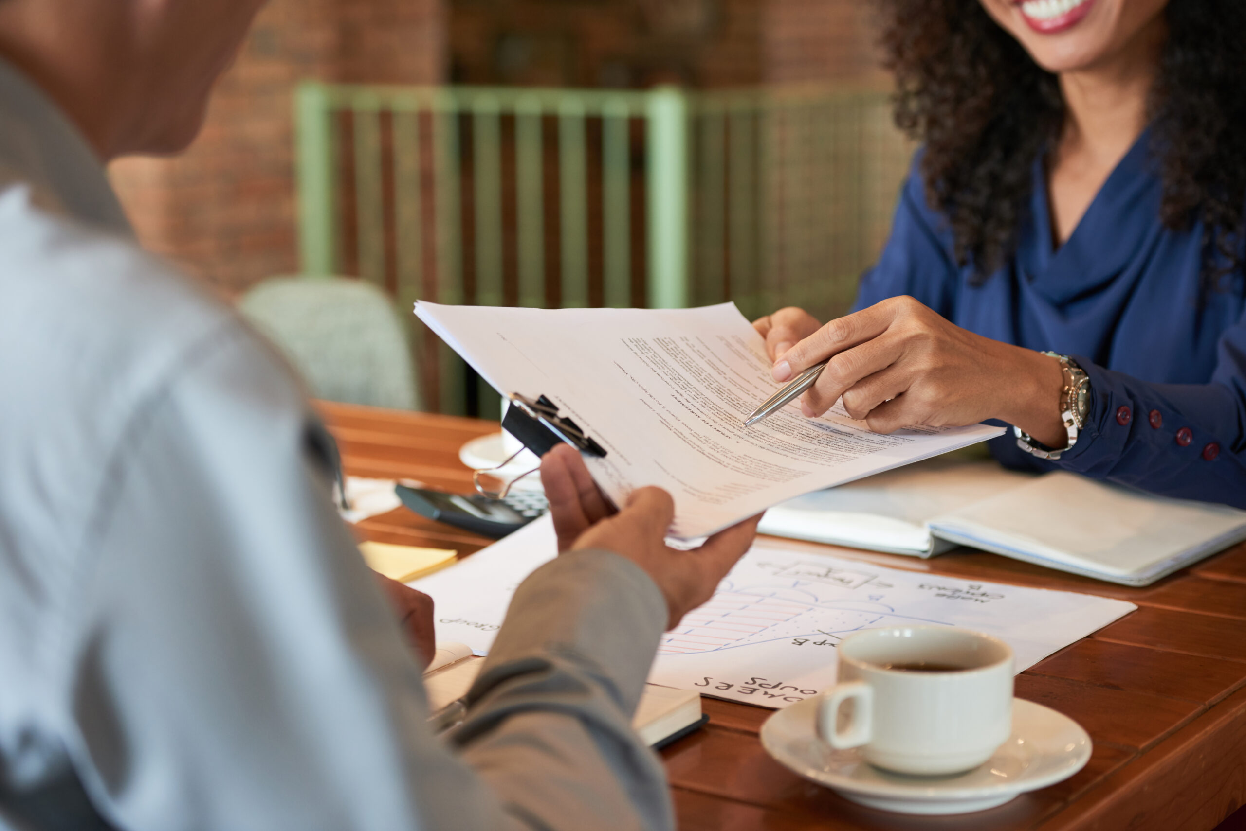 Businessman consulting with lawyer before signing contract